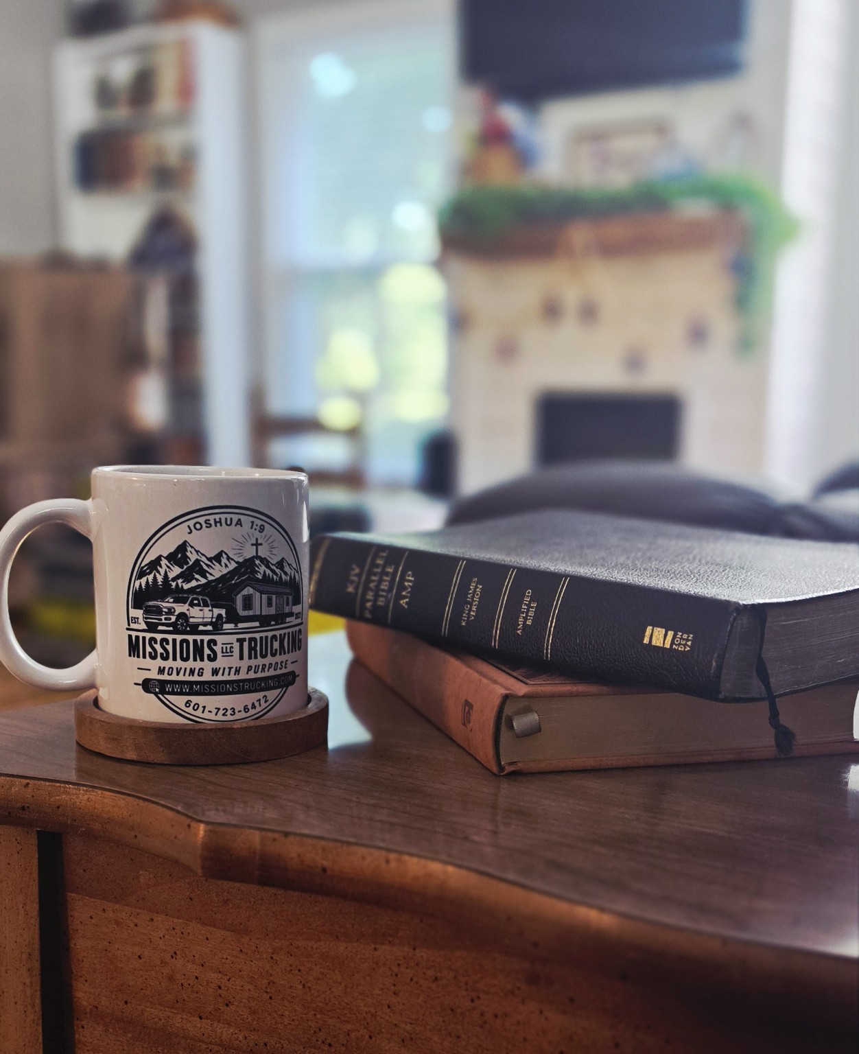 Missions Trucking Moving With Purpose coffee mug beside Bibles